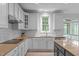 This bright kitchen features white cabinets, stainless appliances, subway tile backsplash, and a window overlooking the yard at 2003 Red Sage Ct, Apex, NC 27502