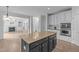 Open concept kitchen with island and breakfast bar, stainless appliances and easy access to a living room with fireplace at 2003 Red Sage Ct, Apex, NC 27502