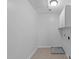 Laundry room featuring a light, cabinets and tile floors at 2003 Red Sage Ct, Apex, NC 27502