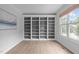 Cozy office featuring built-in bookshelves, hardwood floors, large window and neutral paint at 2003 Red Sage Ct, Apex, NC 27502