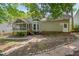 Expansive backyard featuring lush greenery, a screened porch, and a stone pathway, perfect for outdoor enjoyment at 203 N Becket St, Cary, NC 27513