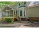 Well-maintained backyard with a screened porch, stairs, and a stone pathway, perfect for outdoor living at 203 N Becket St, Cary, NC 27513