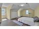 Bright bedroom with wood floors, sloped ceilings, a storage chest, and a modern work desk at 203 N Becket St, Cary, NC 27513