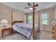 Bedroom featuring a four-poster bed with a ceiling fan and neutral walls, offering a peaceful retreat at 203 N Becket St, Cary, NC 27513