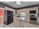 Functional kitchen with island, white countertops, and neutral toned cabinets and backsplash at 203 N Becket St, Cary, NC 27513