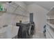 Well-equipped laundry room with modern washer, dryer, sink, and shelving for storage at 203 N Becket St, Cary, NC 27513