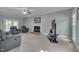 Spacious living room with a fireplace, fan, tile flooring, and a wall-mounted TV setup at 203 N Becket St, Cary, NC 27513