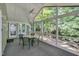 Cozy screened porch featuring a ceiling fan and a dining table set, perfect for outdoor relaxation at 203 N Becket St, Cary, NC 27513