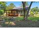 Large backyard with covered porch and mature trees for shade and privacy at 2213 Stephanie Ln, Clayton, NC 27520