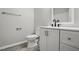Modern bathroom featuring a sleek vanity with black faucet and gray wood-look flooring at 2213 Stephanie Ln, Clayton, NC 27520