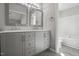 Modern bathroom featuring a double vanity with gray cabinets and framed mirrors at 2213 Stephanie Ln, Clayton, NC 27520