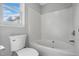 Bathroom with combination tub and shower and modern commode at 2213 Stephanie Ln, Clayton, NC 27520
