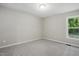 Bedroom with plush carpet, neutral walls, and a window with exterior view at 2213 Stephanie Ln, Clayton, NC 27520