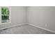 Neutral bedroom featuring plush carpeting and natural light from a window at 2213 Stephanie Ln, Clayton, NC 27520