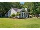 Well-maintained home showcasing lush landscaping and a side entrance at 2213 Stephanie Ln, Clayton, NC 27520