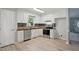 Bright kitchen with stainless steel appliances, white cabinets, and modern backsplash at 2213 Stephanie Ln, Clayton, NC 27520