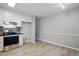 Open concept kitchen features white cabinetry, stainless appliances and eat-in area at 2213 Stephanie Ln, Clayton, NC 27520