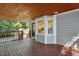 Charming covered porch featuring wood ceiling and views of the backyard at 2213 Stephanie Ln, Clayton, NC 27520