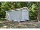 Backyard shed featuring light-blue siding and white trim, providing extra storage at 2213 Stephanie Ln, Clayton, NC 27520