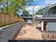 View of a new home's backyard with retaining wall and covered patio at 2321 Turners Aly, Raleigh, NC 27607