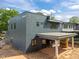 Modern home exterior with gray siding, large windows, and a covered patio area at 2321 Turners Aly, Raleigh, NC 27607