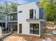 Modern new construction with white and gray siding, black frame windows, and an attached two-car garage at 2321 Turners Aly, Raleigh, NC 27607
