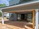 Covered patio with gray siding and large sliding glass doors at 2321 Turners Aly, Raleigh, NC 27607