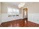 Elegant dining room with chandelier, wood floors, and wainscoting at 234 Lars Ln, Garner, NC 27529