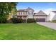 Charming two-story home features a manicured lawn and attached two car garage at 234 Lars Ln, Garner, NC 27529