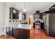 Well-appointed kitchen with stainless steel appliances, granite counters, and dark wood cabinets at 234 Lars Ln, Garner, NC 27529