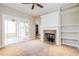 Open living space with fireplace, ceiling fan, and access to outdoor area at 234 Lars Ln, Garner, NC 27529