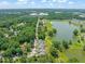 Scenic aerial view of a residential neighborhood nestled among lush green trees and a beautiful pond at 2404 Azalea Dr, Durham, NC 27703