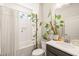 Well-lit bathroom with subway tile shower, plant life, and modern fixtures at 2404 Azalea Dr, Durham, NC 27703