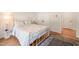 Bedroom with wood floors features queen size bed with blue floral comforter and rug at 2404 Azalea Dr, Durham, NC 27703