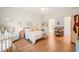 Bright bedroom with wood floors features a crib, seating and ensuite bathroom at 2404 Azalea Dr, Durham, NC 27703