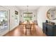 Dining room featuring hardwood floors, a modern table, and natural light from the outdoor views at 2404 Azalea Dr, Durham, NC 27703