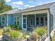 Charming screened porch with patio and well-manicured garden, perfect for outdoor relaxation at 2404 Azalea Dr, Durham, NC 27703