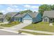 Charming blue home with a well-manicured lawn and attached garage at 2404 Azalea Dr, Durham, NC 27703
