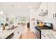Bright kitchen featuring stainless steel appliances, granite countertops, and a view of the dining area at 2404 Azalea Dr, Durham, NC 27703