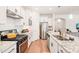 Contemporary kitchen features stainless appliances, granite counters, and ample cabinet space at 2404 Azalea Dr, Durham, NC 27703