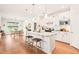Modern kitchen with white cabinetry, granite countertops, stainless steel appliances and island seating at 2404 Azalea Dr, Durham, NC 27703