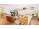 Inviting living room with a mustard sectional sofa, media center, and a comfortable leather chair at 2404 Azalea Dr, Durham, NC 27703