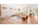 Bright living room with a comfortable yellow sectional, hardwood floors, and plenty of natural light at 2404 Azalea Dr, Durham, NC 27703