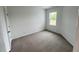 Cozy bedroom with neutral carpet and bright window with nature view at 2411 Whitewing Ln, Wendell, NC 27591