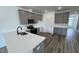 Open kitchen boasts stainless steel appliances, grey cabinets, and an island with a sink at 2411 Whitewing Ln, Wendell, NC 27591