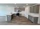 Modern kitchen features stainless steel appliances, white quartz countertops, and grey cabinets at 2411 Whitewing Ln, Wendell, NC 27591