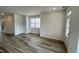 Spacious living room with hardwood floors and a doorway leading to the staircase at 2411 Whitewing Ln, Wendell, NC 27591