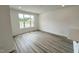 Bright living room with hardwood floors and a large window offering ample natural light at 2411 Whitewing Ln, Wendell, NC 27591
