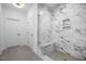 Marble shower with frameless glass door and bench seat in modern bathroom at 2617 Packhouse Rd, Zebulon, NC 27597