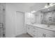 Modern bathroom with dual vanity, marble shower with glass door, and contemporary lighting fixtures at 2617 Packhouse Rd, Zebulon, NC 27597